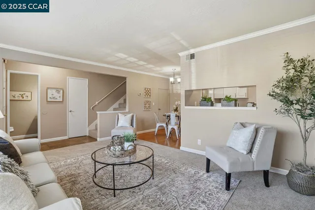 a living room with furniture and a dining table