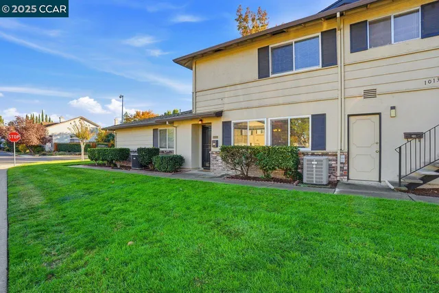 a front view of a house with a yard and porch