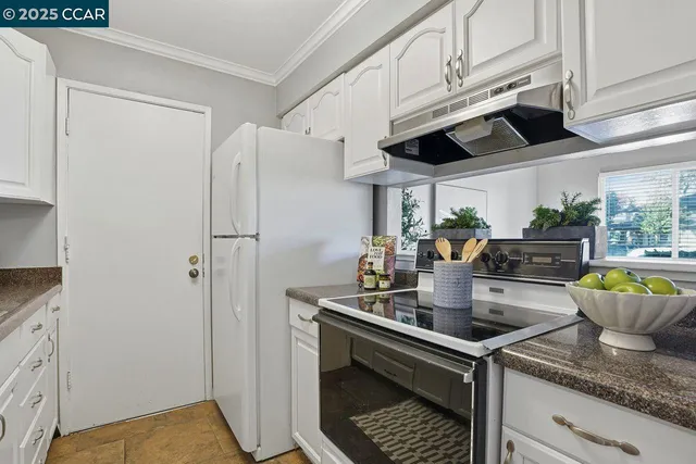 a kitchen with stainless steel appliances granite countertop a sink a stove and a refrigerator