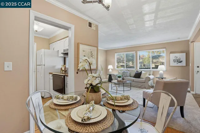 a dining room with furniture a rug and wooden floor