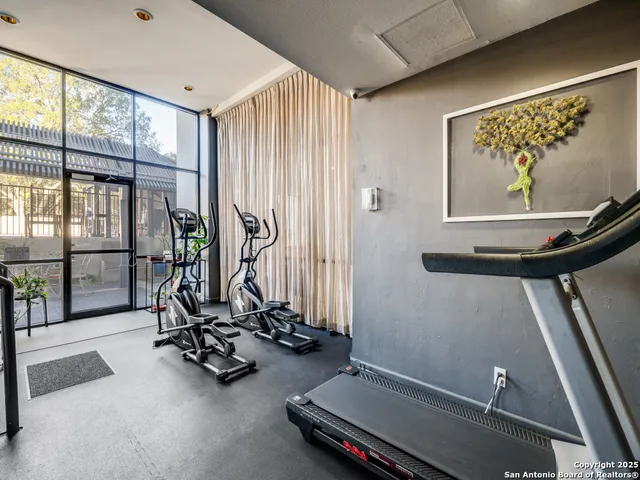 a room with gym equipment and large window
