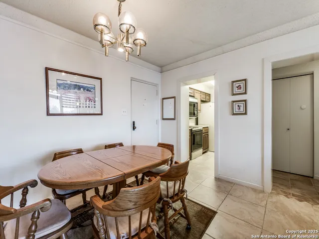a view of a dining room with furniture and chandelier
