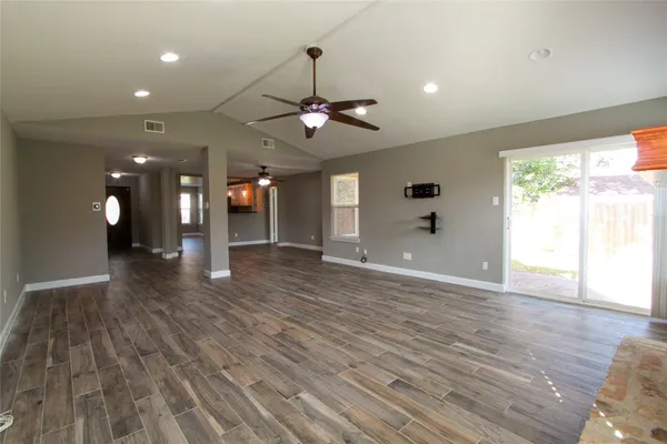 wooden floor in an empty room with a window