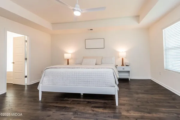 a bedroom with a bed and a night stand