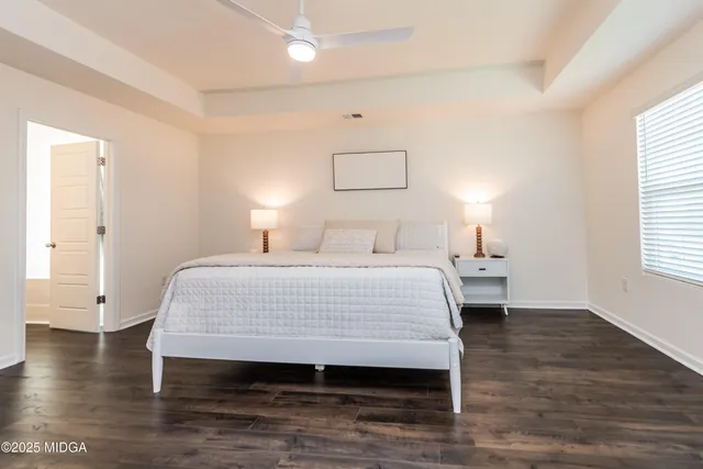 a bedroom with a bed and a night stand