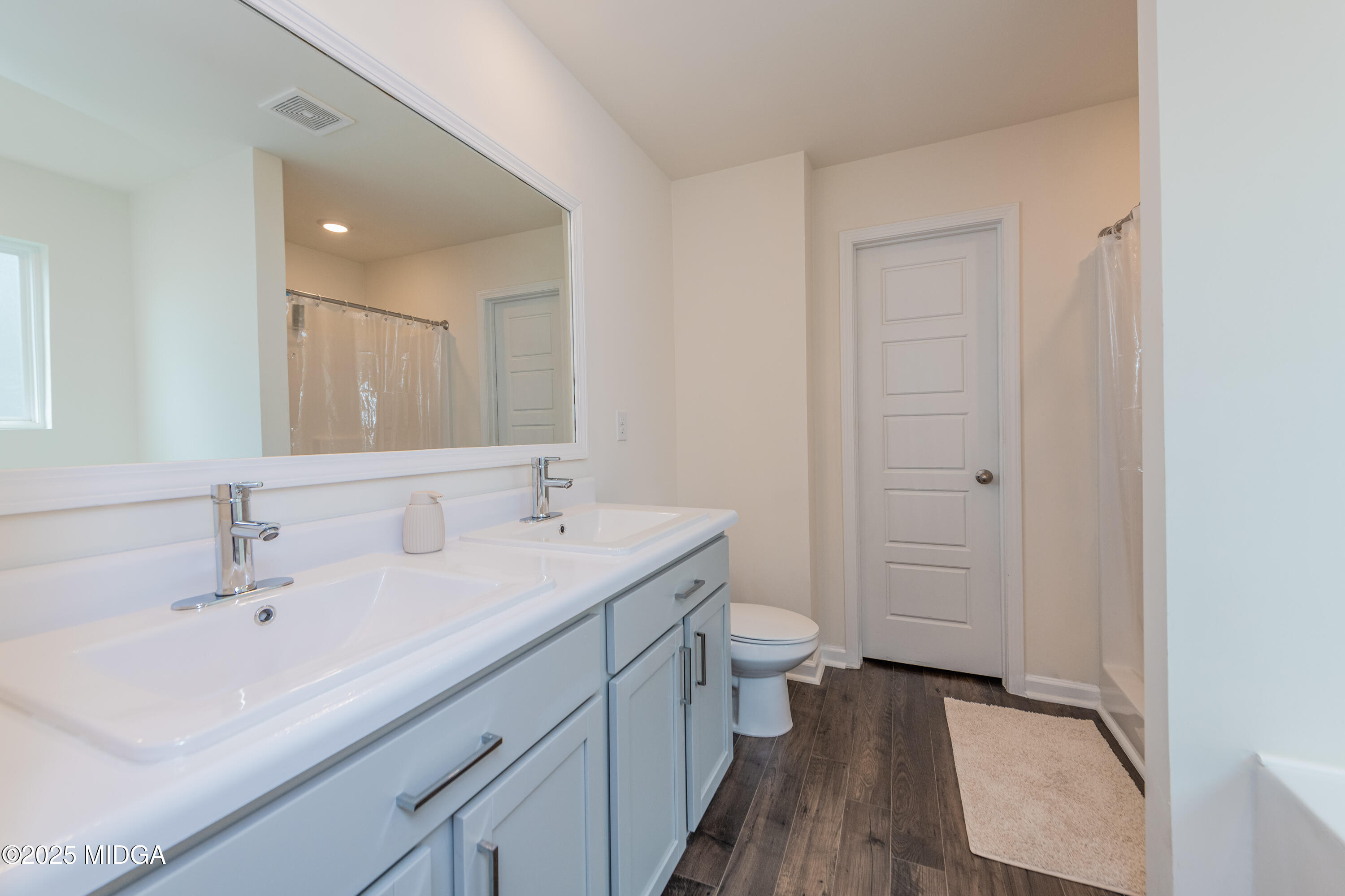126 Farmers Way Perry, GA 31069 - Photo 15 of 33 a bathroom with a double vanity sink toilet and shower