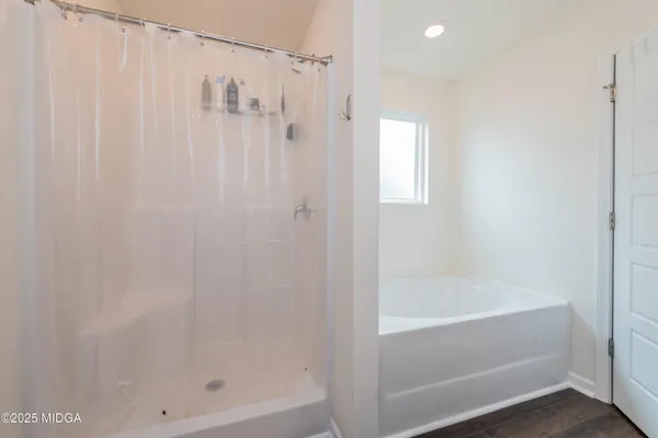 a bathroom with a shower and a bath tub