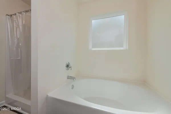 a white bath tub sitting next to a small window