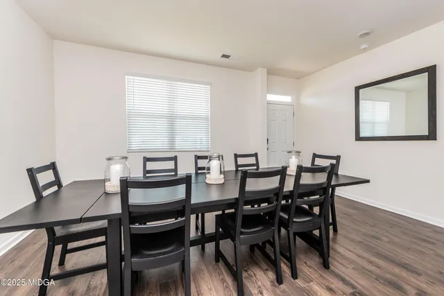 a view of a dining room with furniture and wooden floor
