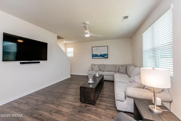 a living room with furniture and a flat screen tv