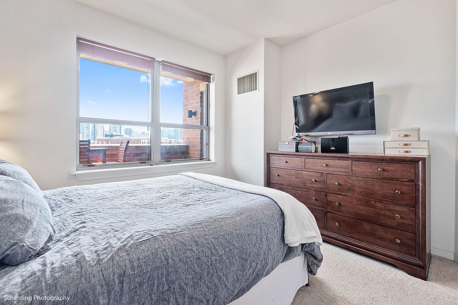 437 West Division Street, Unit 806 Chicago, IL 60610 - Photo 10 of 18 a bedroom with a bed and a flat screen tv