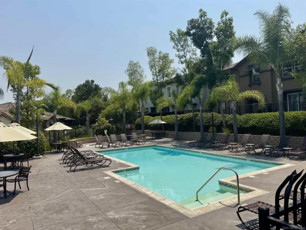 a view of a swimming pool with chairs in patio