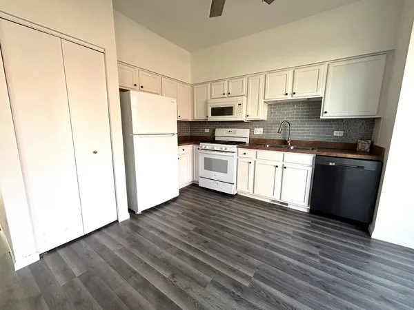 a kitchen with stainless steel appliances a refrigerator sink and cabinets