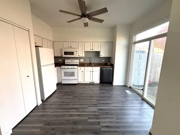 a kitchen with a refrigerator a stove top oven and kitchen island