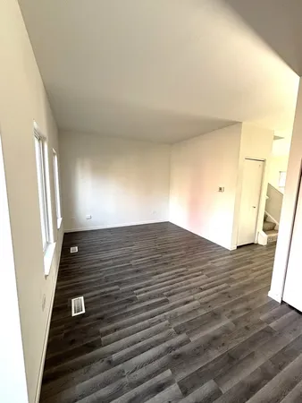 a view of an empty room and wooden floor