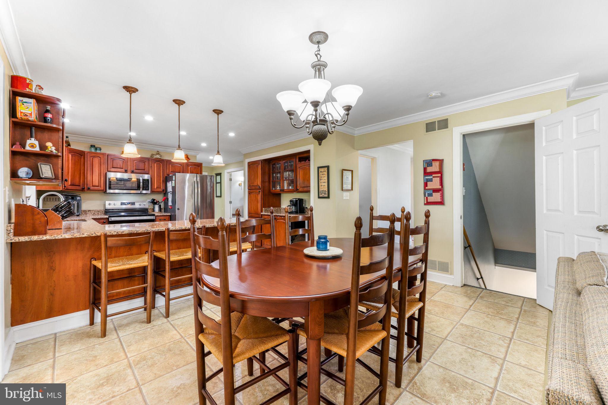 21310 West Liberty Road Parkton, MD 21120 - Photo 25 of 111 a dining room filled with lots of furniture and a chandelier