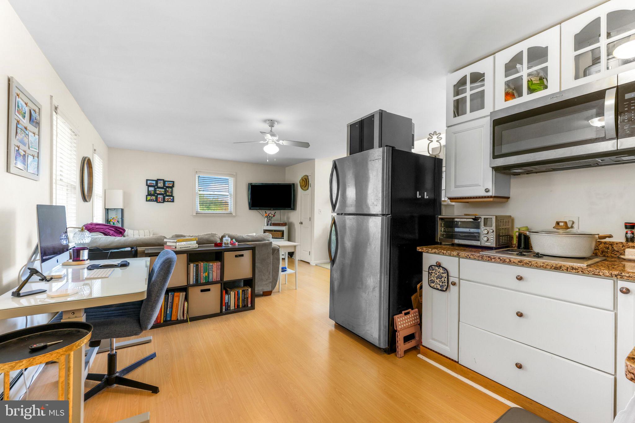 21310 West Liberty Road Parkton, MD 21120 - Photo 54 of 111 a kitchen with stainless steel appliances a refrigerator a stove a sink a dining table and chairs with wooden floor