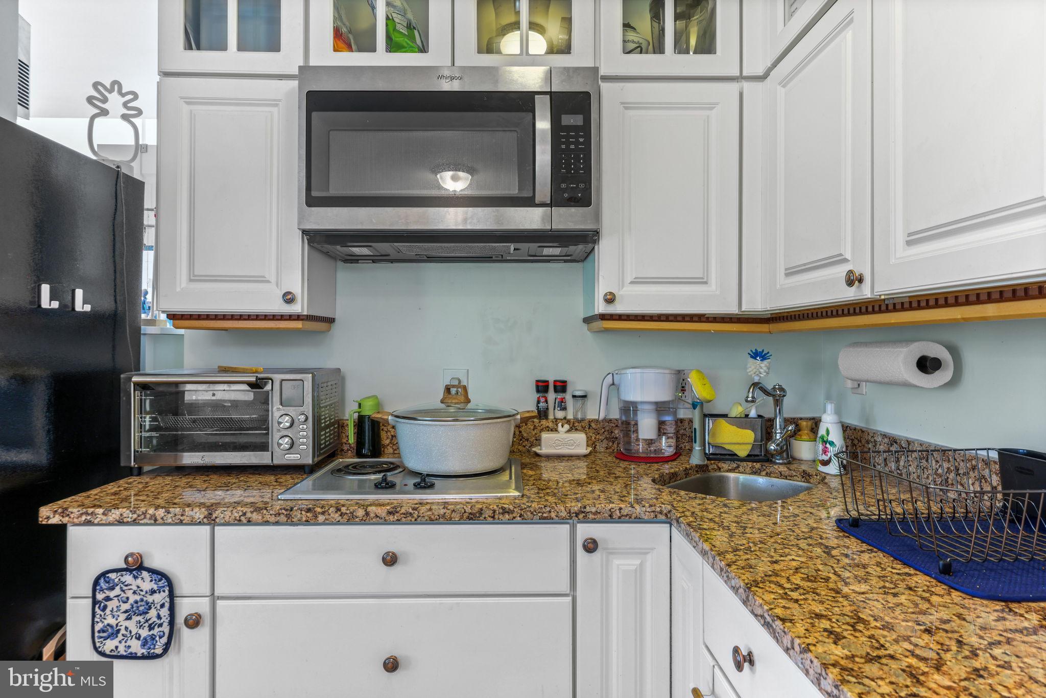 21310 West Liberty Road Parkton, MD 21120 - Photo 64 of 111 a kitchen with granite countertop a stove a microwave and cabinets