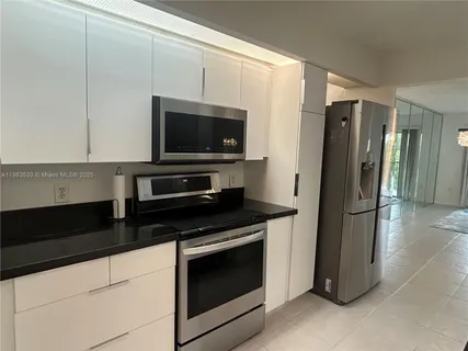 a kitchen with a refrigerator stove and microwave