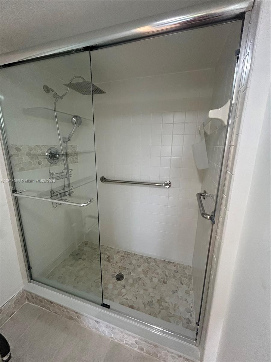 901 Southwest 141st Avenue, Unit 409M Pembroke Pines, FL 33027 - Photo 4 of 10 a bathroom with a shower