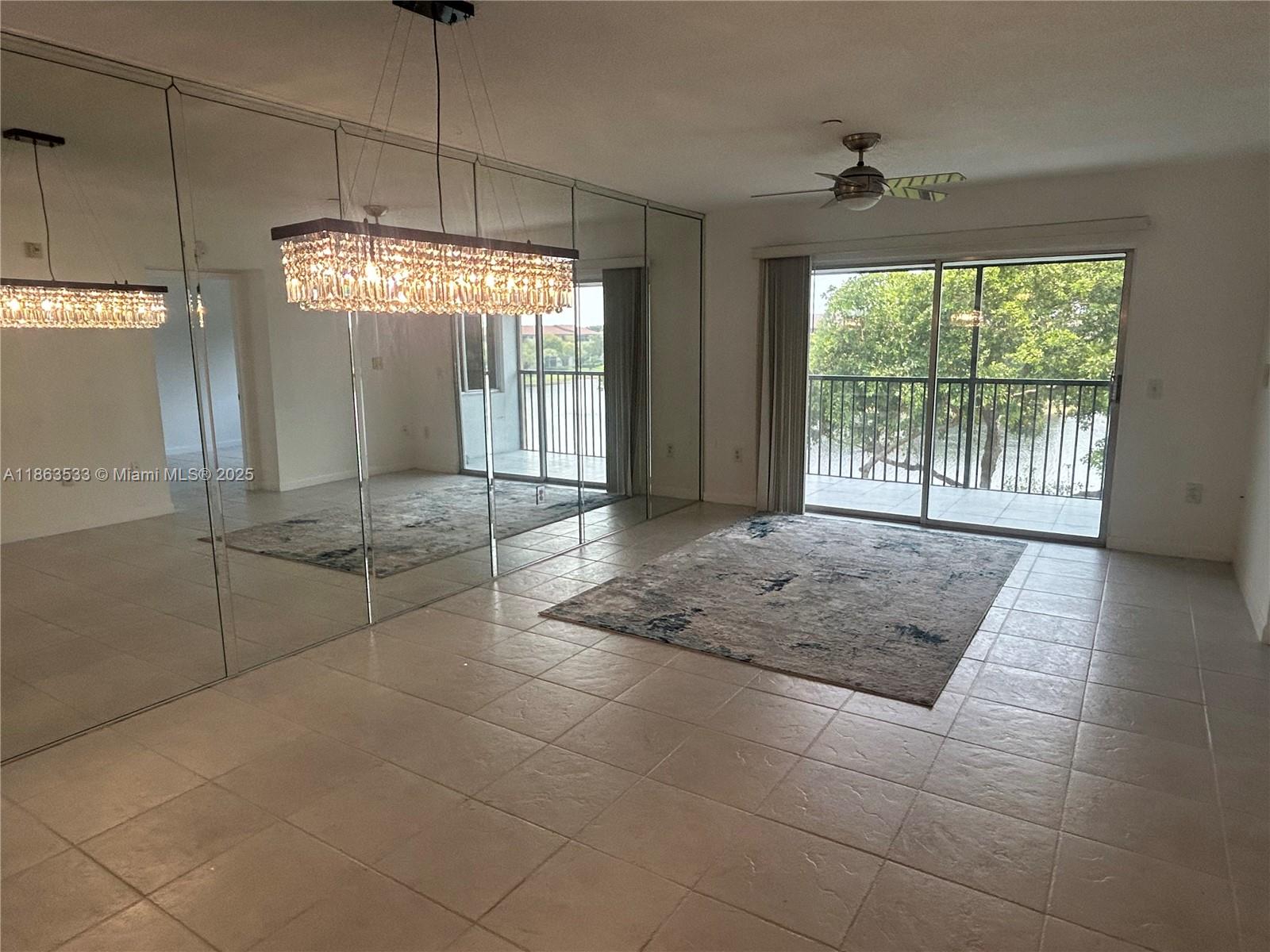 901 Southwest 141st Avenue, Unit 409M Pembroke Pines, FL 33027 - Photo 6 of 10 a view of an empty room with a window