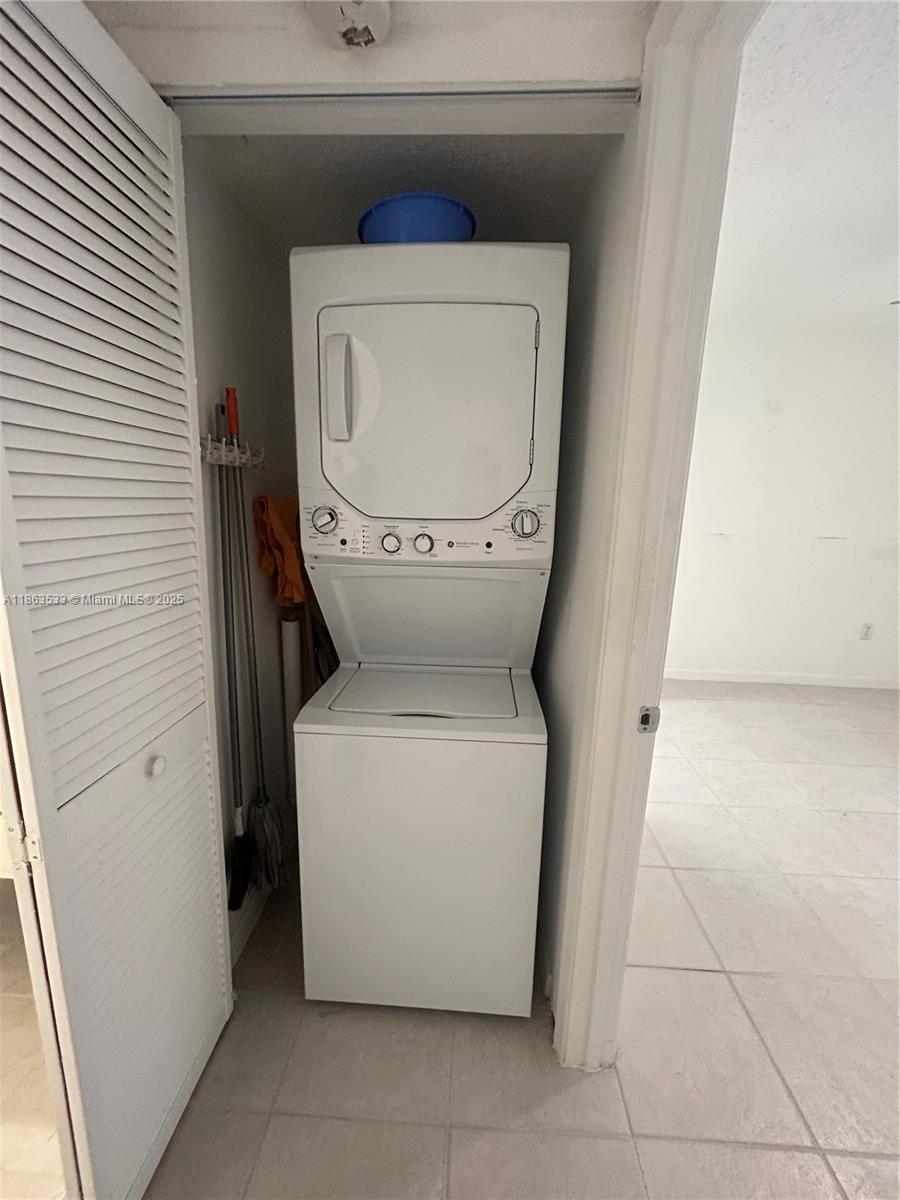 901 Southwest 141st Avenue, Unit 409M Pembroke Pines, FL 33027 - Photo 9 of 10 a utility room with dryer and washer