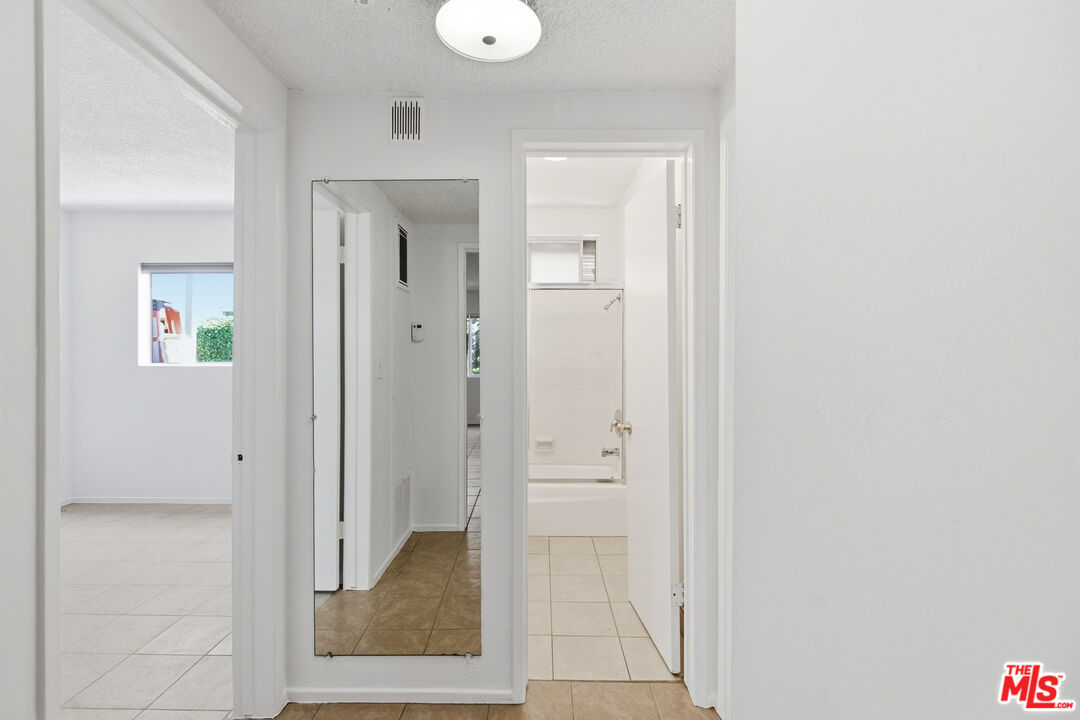1434 25th Street, Unit 2 Santa Monica, CA 90404 - Photo 14 of 26 a view of a hallway with wooden floor and a bathroom