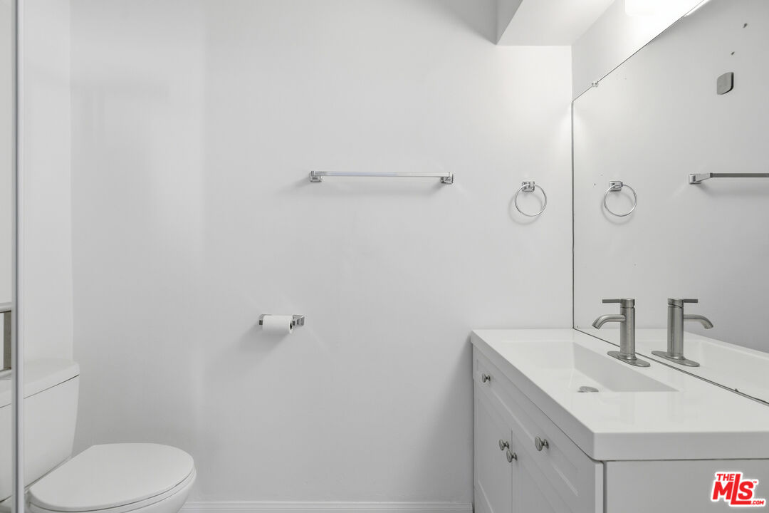 1434 25th Street, Unit 2 Santa Monica, CA 90404 - Photo 20 of 26 a bathroom with a sink toilet and vanity