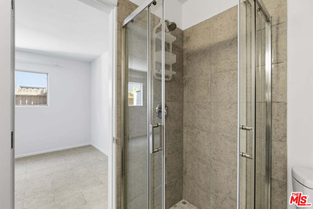 1434 25th Street, Unit 2 Santa Monica, CA 90404 - Photo 21 of 26 a bathroom with a shower and a glass door