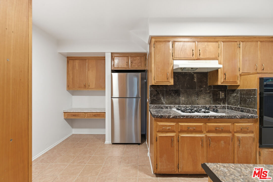1434 25th Street, Unit 2 Santa Monica, CA 90404 - Photo 5 of 26 a kitchen with stainless steel appliances granite countertop a stove a refrigerator and a microwave