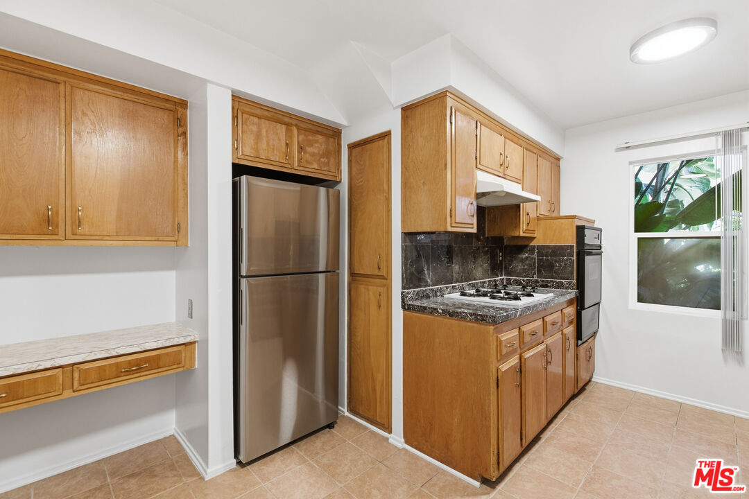 1434 25th Street, Unit 2 Santa Monica, CA 90404 - Photo 7 of 26 a kitchen with stainless steel appliances granite countertop a stove a refrigerator and a refrigerator