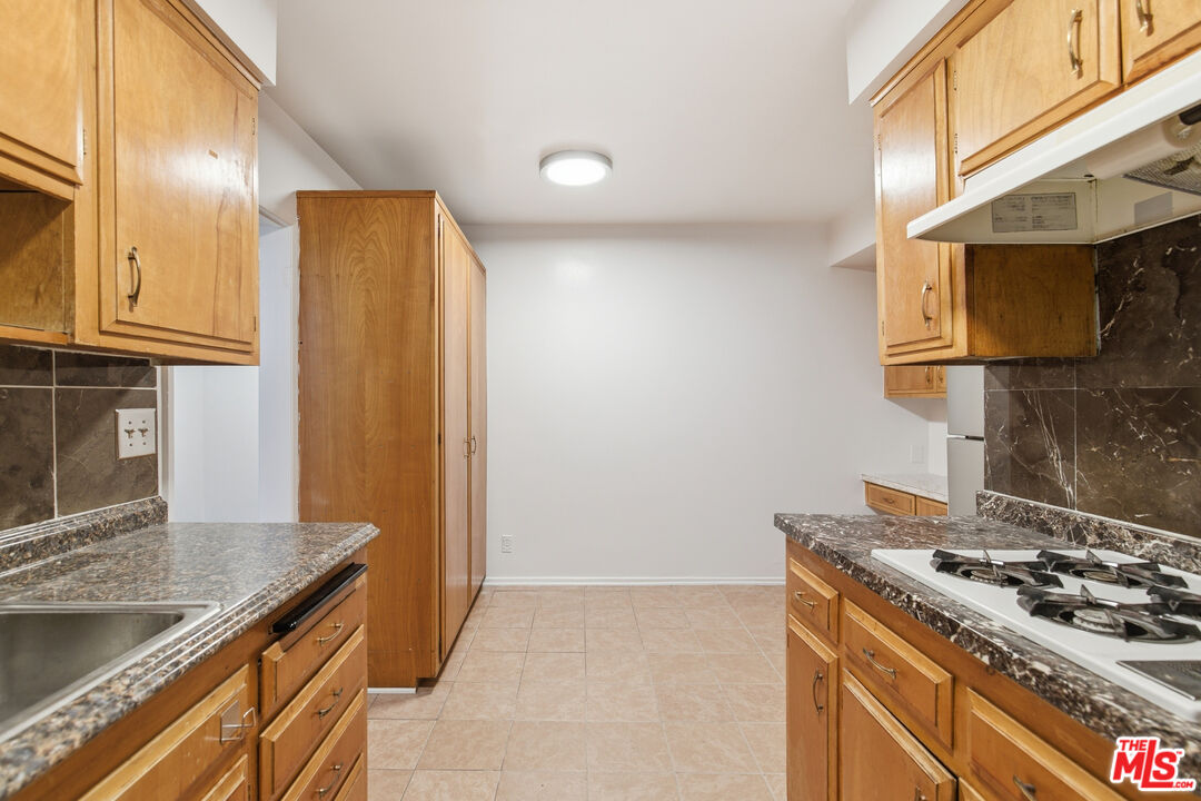 1434 25th Street, Unit 2 Santa Monica, CA 90404 - Photo 9 of 26 a kitchen with a stove and a refrigerator