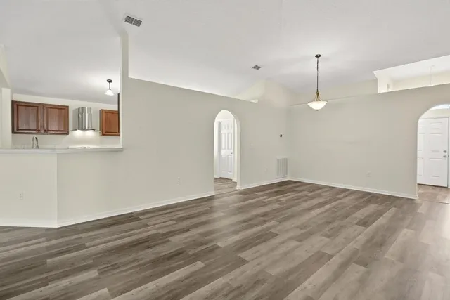 a view of a kitchen with a sink and a refrigerator