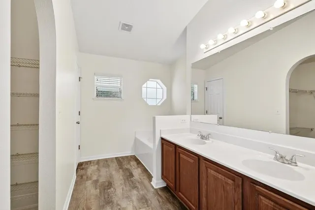 a view of a backyard with plants and a fountain