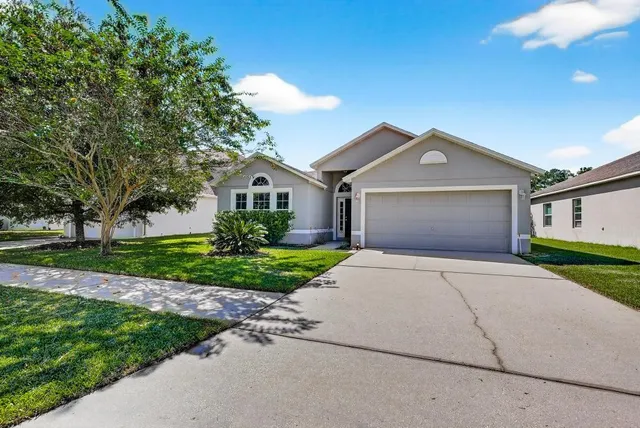 a front view of a house with a yard and porch