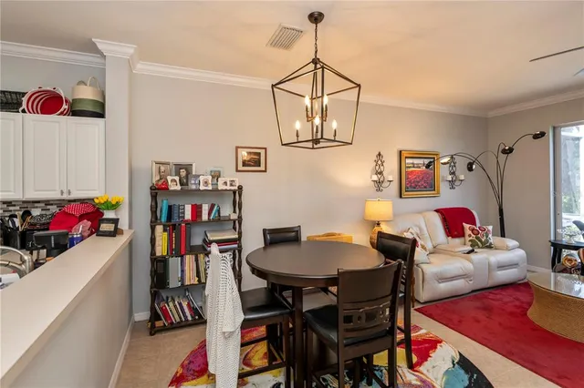 a dining room with furniture and chandelier