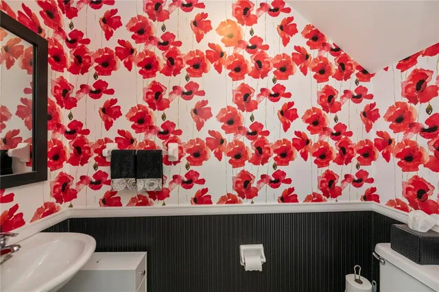 a bedroom with bed mirror and window