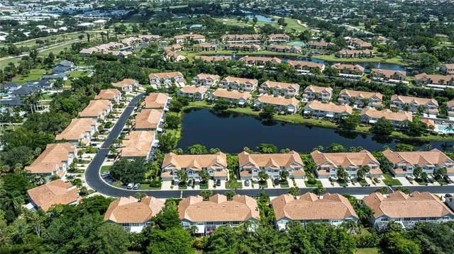 an aerial view of residential houses with outdoor space and swimming pool