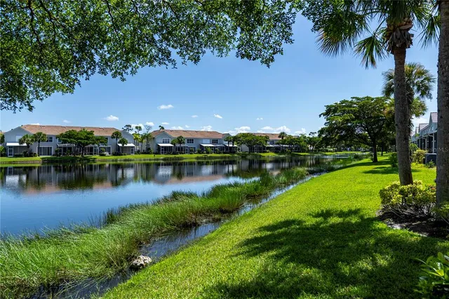 an aerial view of a house with a yard and lake view