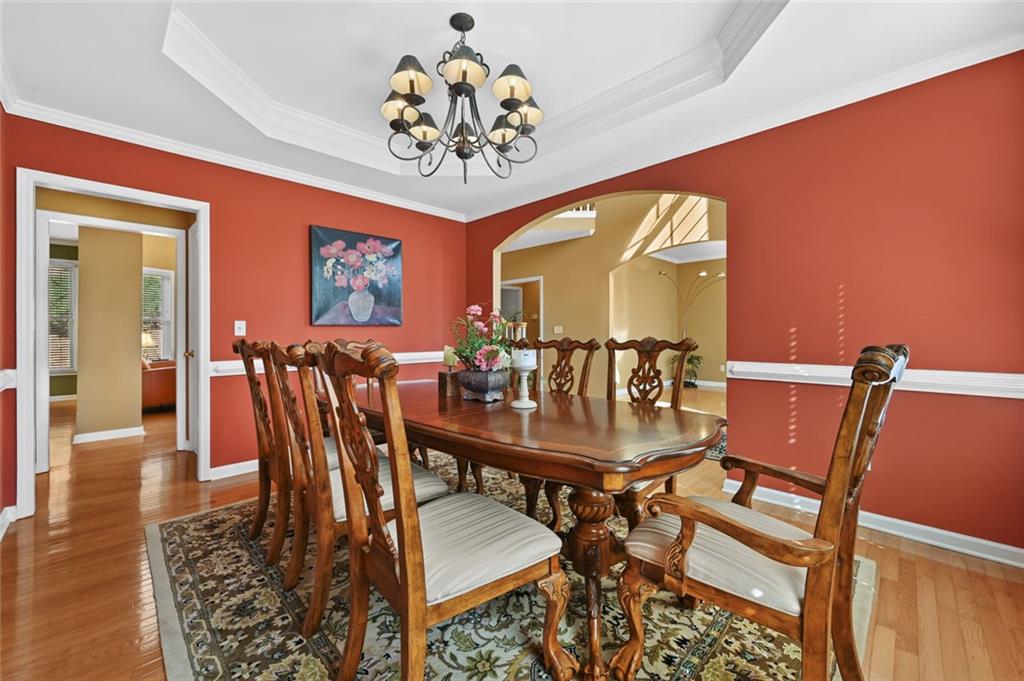 3945 Summit Gate Drive Suwanee, GA 30024 - Photo 16 of 45 a view of a dining room with furniture and a chandelier