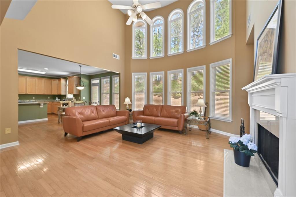 3945 Summit Gate Drive Suwanee, GA 30024 - Photo 17 of 45 a living room with furniture fireplace and a large window