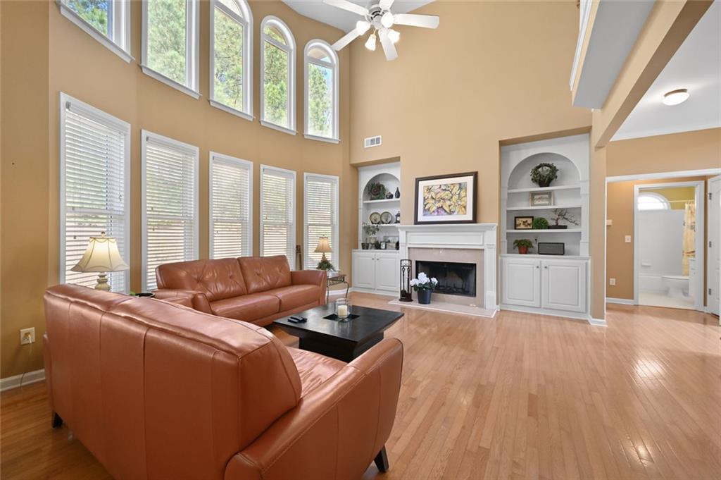 3945 Summit Gate Drive Suwanee, GA 30024 - Photo 18 of 45 a living room with furniture large window and fireplace