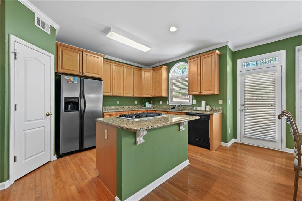 3945 Summit Gate Drive Suwanee, GA 30024 - Photo 22 of 45 a kitchen with stainless steel appliances granite countertop a refrigerator a sink and a stove