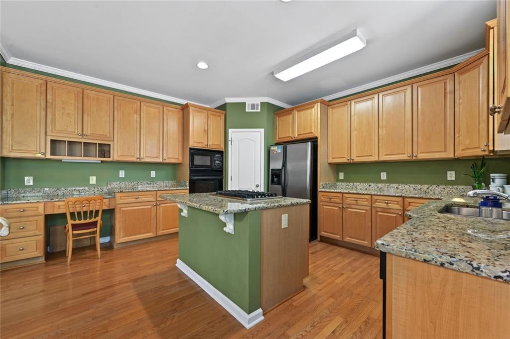 3945 Summit Gate Drive Suwanee, GA 30024 - Photo 23 of 45 a kitchen with stainless steel appliances granite countertop a stove a sink dishwasher a refrigerator and a microwave