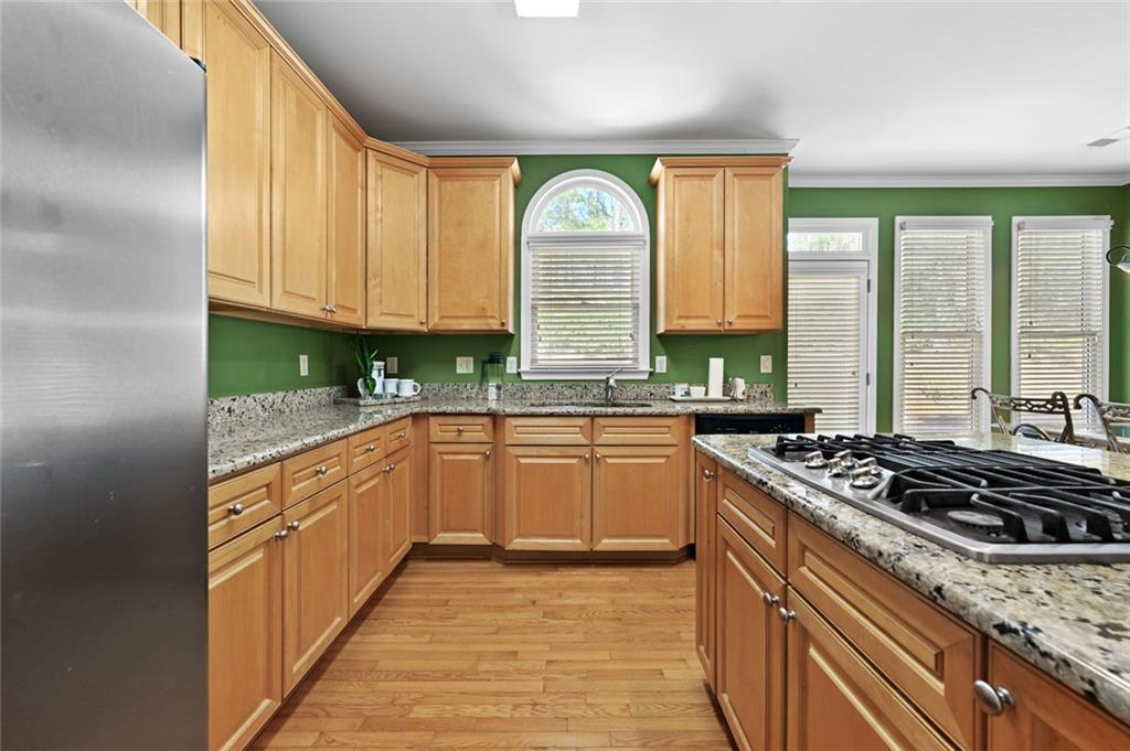 3945 Summit Gate Drive Suwanee, GA 30024 - Photo 25 of 45 a kitchen with stainless steel appliances granite countertop a stove a sink and a refrigerator