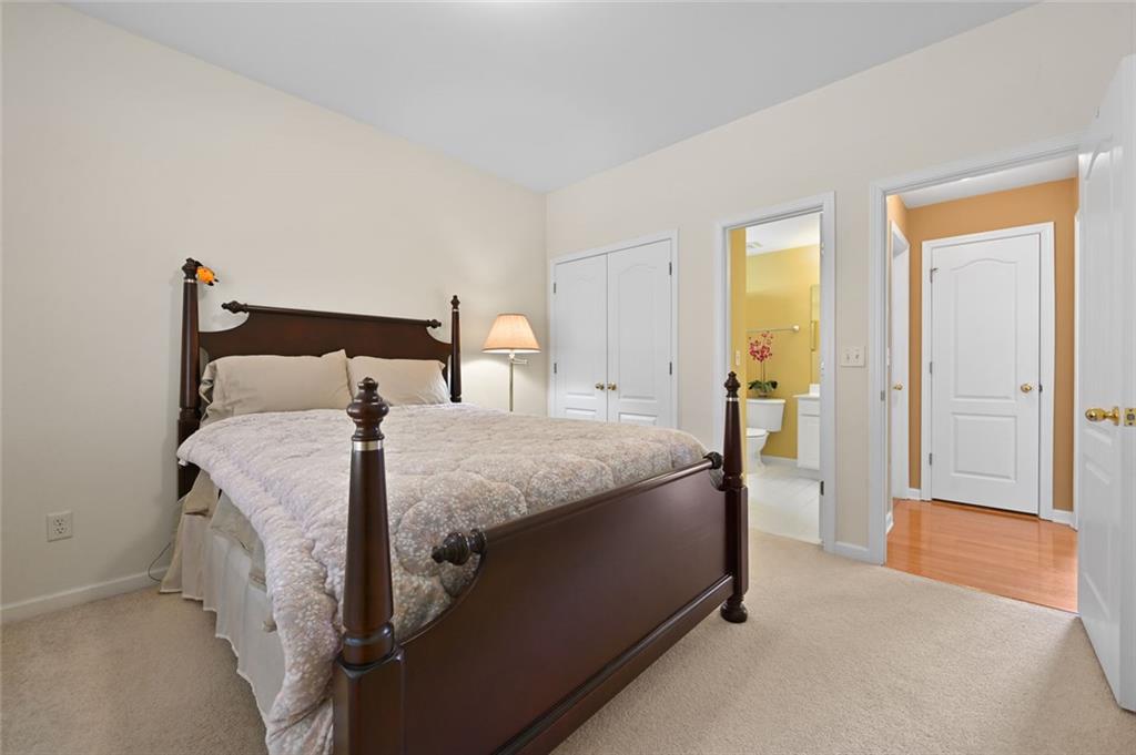 3945 Summit Gate Drive Suwanee, GA 30024 - Photo 27 of 45 a spacious bedroom with a bed and a table