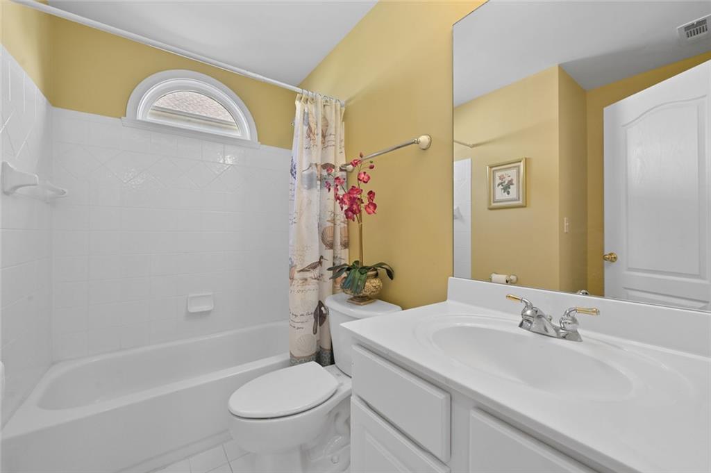 3945 Summit Gate Drive Suwanee, GA 30024 - Photo 28 of 45 a bathroom with a sink a toilet and shower