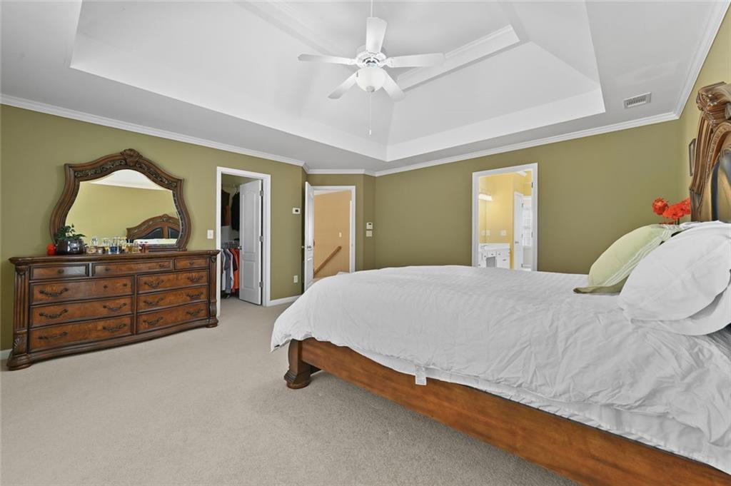 3945 Summit Gate Drive Suwanee, GA 30024 - Photo 31 of 45 a spacious bedroom with a bed and a dresser