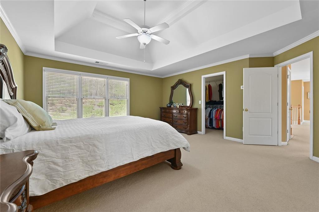 3945 Summit Gate Drive Suwanee, GA 30024 - Photo 32 of 45 a bed sitting in a spacious bedroom next to a window
