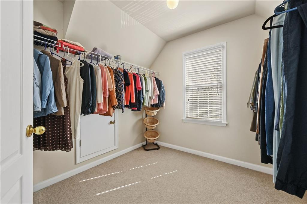 3945 Summit Gate Drive Suwanee, GA 30024 - Photo 35 of 45 a view of walk in closet with clothes and shoes